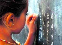 A child writes alphabets in a reverse order