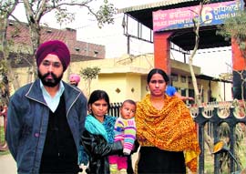 Victims, who were illegaly confined in a house, standing outside a police station along with their advocate, in Ludhiana on Saturday