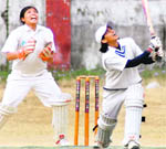 A player hits a shot at the final of the Women Cricket League Tournament in Dehradun