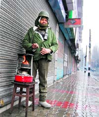 A jawan warms himself in the Lal Chowk area in Srinagar on Sunday