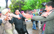 The police tries to control Utsav Sharma, holding a knife in his hand, after he attacked SPS Rathore outside the District Courts in Chandigarh on Monday. 