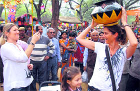 A foreigner strikes a pose during the Surajkund Crafts Mela in Faridabad.