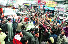 Passengers stranded on the Srinagar-Jammu highway hold a protest in support of their demand for arrangements for stay in Jammu on Monday