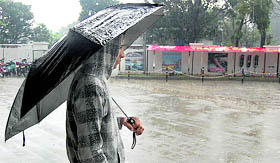A lone youth braves the chill and rain.