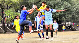 Players in action in a rain soaked match at the Presidents Cup Football Tournament in Dehradun on Tuesday.