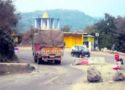 A truck driver negotiates the narrow opening on the national highway blocked almost half by the Bilaspur district administration