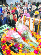 People pay tributes to Santokh Singh Dhir outside his residence in Mohali on Tuesday. 