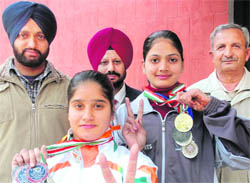 Winners of All-India Inter-University Gymnastics Championship with their medals