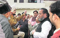A police official pacifies the two sides over the custody of an orphaned boy in Chandigarh
