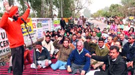 Members of the Punjab and Chandigarh College Teachers' Union hold a dharna in protest against the government in Jalandhar on Wednesday