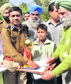 Eleven-year-old Gurjeevan Singh is honoured by DIG Jitendera Jain in Bathinda on Thursday. 