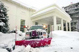 A plough at work to remove snow outside the West Wing of the White House in Washington. A blizzard howled up the East Coast on Wednesday. Washington has set a record for snowfall since 1899.