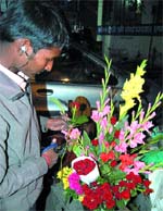 A flower vendor arranges flowers on Lawrence Road in Amritsar on Friday