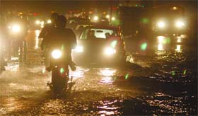 Traffice crawls after the evening downpour in New Delhi on Friday.