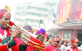 Fans and supporters of Shah Rukh Khan celebrate outside Delite Cinema in New Delhi on Friday.