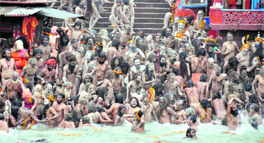 Naga sadhus of the Juna Akhada take a dip during the first Shahi Snan in the Ganga in Haridwar on Friday.