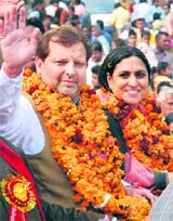 MP Arvind Sharma with MLA Sumita Singh waves at the crowd during a Shobha Yatra on Mahashivratri in Karnal on Friday.