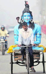 A rickshaw carries an idol of Lord Shiva in New Delhi