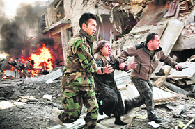 Adam Ferguson, a photographer for VII Mentor Program for The New York Times based in Australia, won the first prize in the Spot News Singles category for this picture of an Afghan woman being rushed from the scene of a suicide bombing in Kabul.