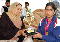 Sulochana receiving best athlete trophy during Annual Sports Day of the Bhag Singh Hayer College for Women in Abohar on Saturday.