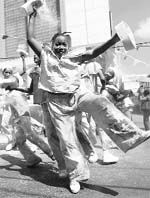 Children dance and throw powder as they parade as Fancy Sailors during the Traditional Carnival Characters Festival in Port of Spain.