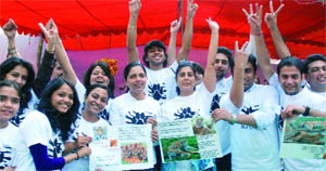 Youngsters from 'Save the Stripes' organisation take part in an awareness programme to save tigers, at Jantar Mantar in New Delhi on Sunday.