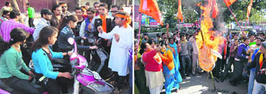 Activists of the ABVP have a word with youngsters in Haridwar on Valentines Day; and (right) Shiv Sena workers burn an effigy in Dehradun on Sunday.