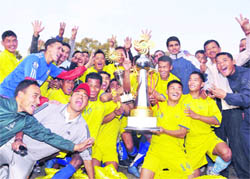 2/3 Gorkha Rifles team members pose with the trophy after winning the President's Cup Football Tournament in Dehradun on Sunday.