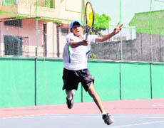   A player in action at the 10th State Open Junior Tennis Tournament held at Shanti Tennis Academy in Dehradun on Sunday.