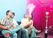 Youngsters enjoy smoking at Sheesha Restaurant in Dehradun. 