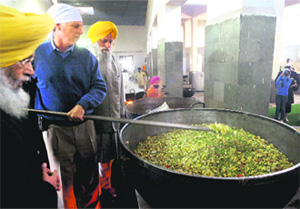 US Ambassador Timothy J Roemer performs sewa at the Langar Ghar during his visit to the Golden Temple in Amritsar on Sunday.