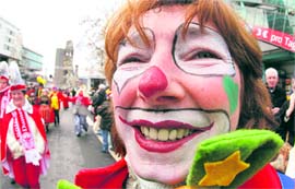 A carnival reveller celebrates in the city center near the Kurfuerstendamm boulevard in Berlin on Sunday.