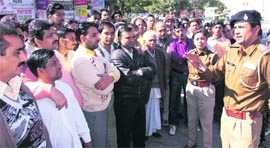 The SHO of the Sector 19 police station, Ram Gopal, urges shopkeepers of the Sector 19 market to contact the police regarding any suspected item they notice lying abandoned, in the wake of the recent bomb blast in Pune, 
