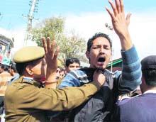 State president of the NSUI, Yadhupati Thakur, in a scuffle with a cop during a BJP rally at Dharamsala on Monday.