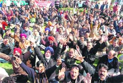 Members of the J&K Government Employees Joint Consultative Committee protest in support of their demands in Jammu on Monday.