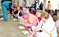 Russian disciples of Swami Vishnudevanand have food at the akhada of Pilot Baba in Haridwar.