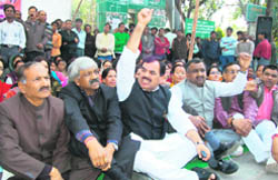 Leader of Opposition Harak Singh Rawat (with his arm raised) holds a protest in Dehradun