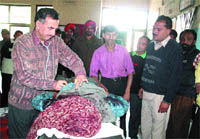 A doctor examines Subhash Chander, who was brought dead to the hospital, in Jalandhar 