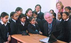 Keith Rogers interacts with students at Cambridge International School.