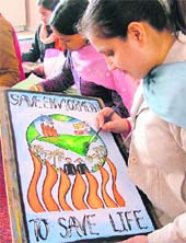 Students of GMT College take part in a competition on saving environment in Ludhiana on Monday.