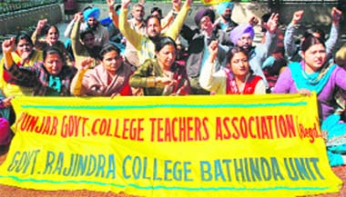 Members of the Punjab Government College Teachers Association stage a protest against the non-implementation of the pay commissions report in toto, in Bathinda on Tuesday.