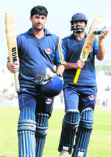 J&Ks Dhruv Mahajan (L) acknowledges the crowd after completing his century on Tuesday.
