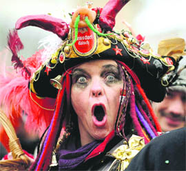 A carnival reveller shouts during the Rose Monday Parade in Cologne, Germany