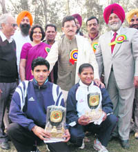 Winners strike a pose with their trophies on the concluding day of the athletics meet in Patiala 