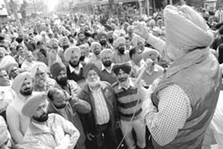Employees of the Punjab State Electricity Board block traffic on the Rajpura-Patiala road