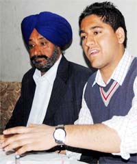 Navjot Singh (right) and his father Jagtar Singh address a press conference in Amritsar