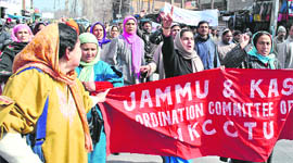 Members of the Jammu and Kashmir Joint Action Committee hold a protest against the non-implementation of the recommendations of the Sixth Pay Commission, at Lal Chowk in Srinagar on Wednesday.