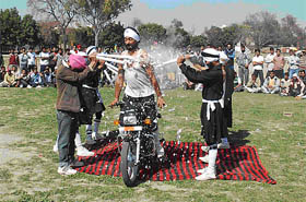 a motorcyclist performs a dare-devil act during the sports meet.