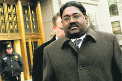 Raj Rajaratnam, billionaire founder of the Galleon Group, a major hedge fund, leaves Manhattan federal court on Wednesday in New York. An October trial date in New York has been set for him, who is charged with the history's largest hedge fund insider trading case.