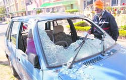 Onkar Singh Mokha shows the broken windowpanes of his Maruti car in Sector 15, Chandigarh, on Thursday. 